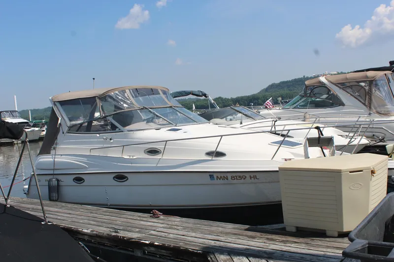 The Image of 2000 Regal Commodore 2760 boat docked at marina under clear sky. - 1