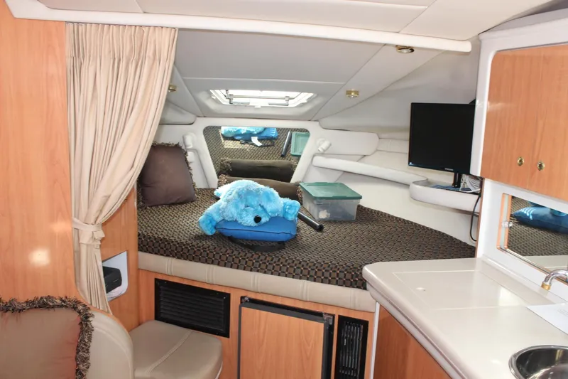 Slide: The Image of Interior of 2000 Regal Commodore 2760 boat with cozy cabin and plush decor. - 14