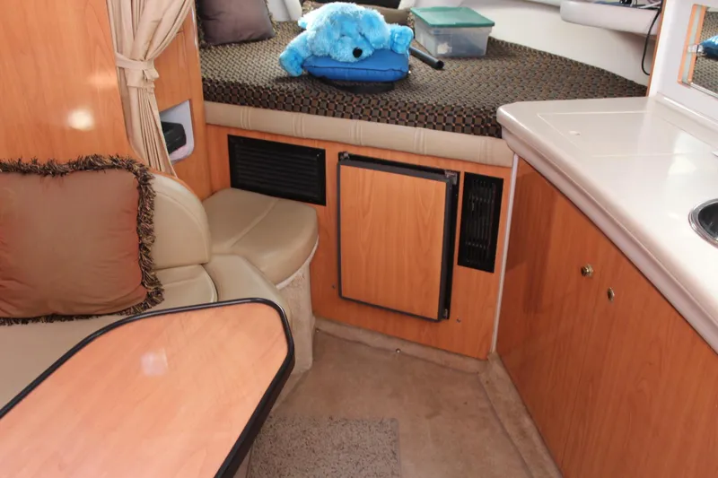 Slide: The Image of Interior of 2000 Regal Commodore 2760 boat with seating, table, and plush toy. - 15