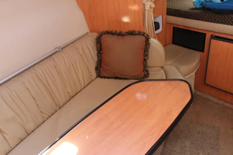 Slide: The Image of Interior of 2000 Regal Commodore 2760 with beige seating and wooden table. - 16