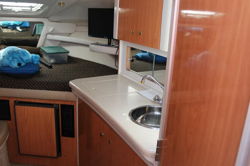 Slide: The Image of 2000 Regal Commodore 2760 cabin interior with kitchenette and sleeping area. - 17