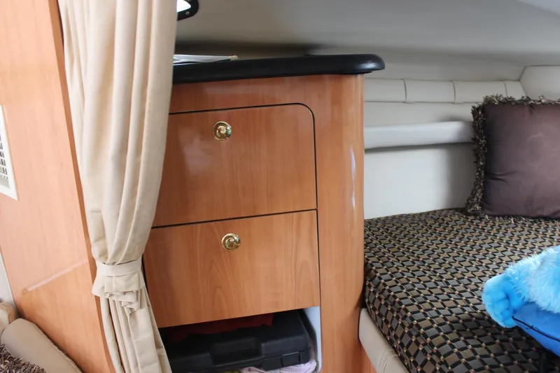 Slide: The Image of Interior of 2000 Regal Commodore 2760 with wooden cabinetry and patterned bedding. - 18