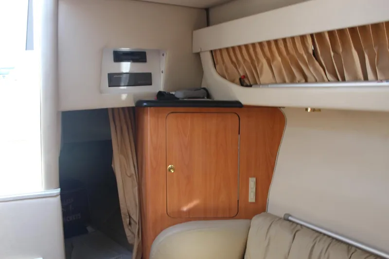 Slide: The Image of Interior of 2000 Regal Commodore 2760 boat with wood cabinet and beige curtains. - 21