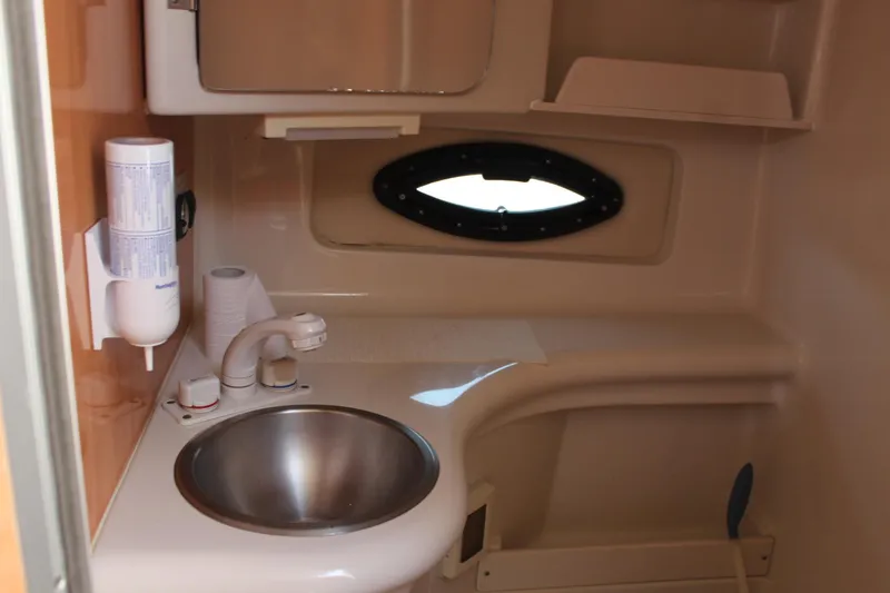 Slide: The Image of 2000 Regal Commodore 2760 boat bathroom with sink and porthole window. - 23