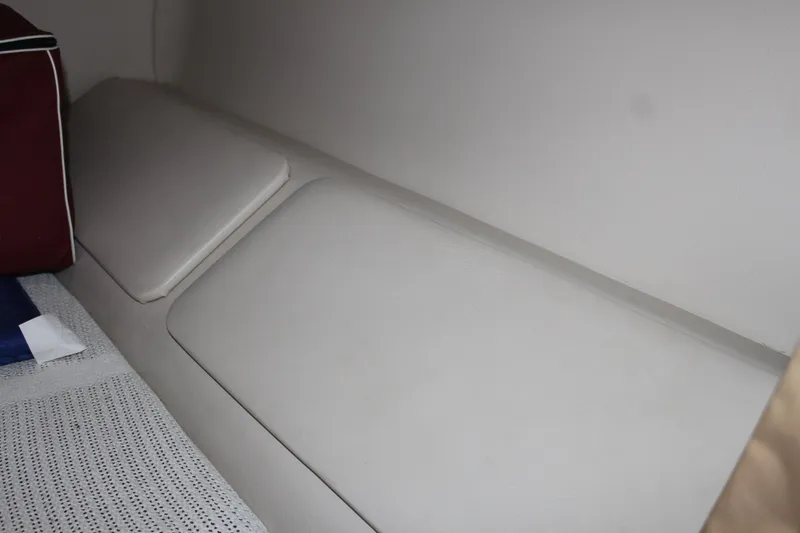 Slide: The Image of Interior seating of 2000 Regal Commodore 2760 boat, featuring white cushions. - 24