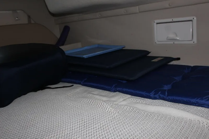 Slide: The Image of Interior cabin of 2000 Regal Commodore 2760 with cushions and storage compartment. - 25