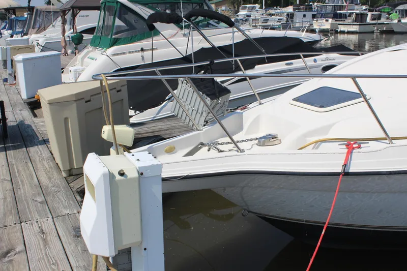 Slide: The Image of Docked 2000 Regal Commodore 2760 boat with other vessels in marina. - 3