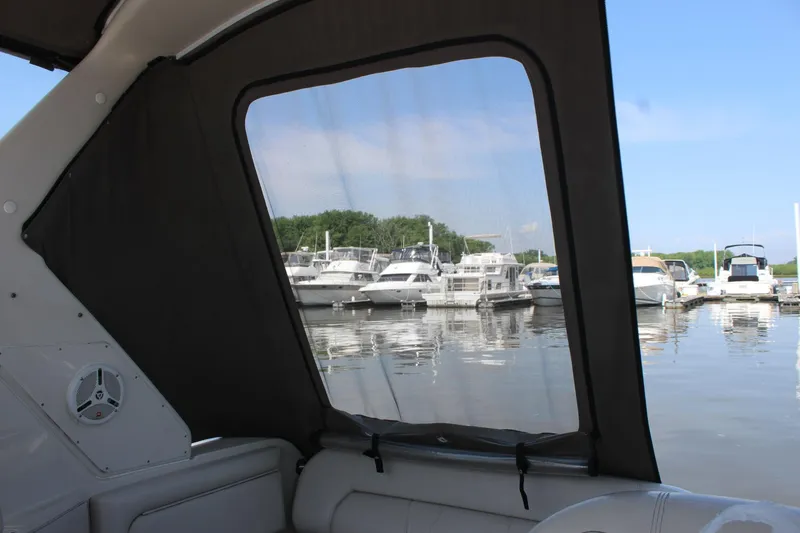 Slide: The Image of View from inside a 2000 Regal Commodore 2760 boat, overlooking a marina with docked boats. - 4