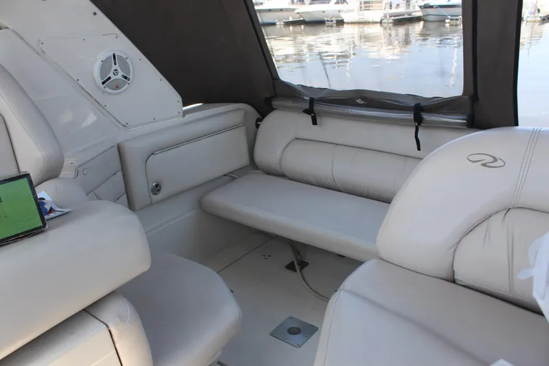 Slide: The Image of 2000 Regal Commodore 2760 boat interior with beige seating and marina view. - 5