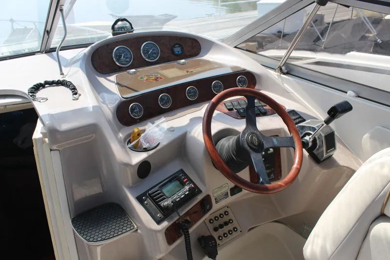Slide: The Image of 2000 Regal Commodore 2760 boat cockpit with steering wheel and control panel. - 7