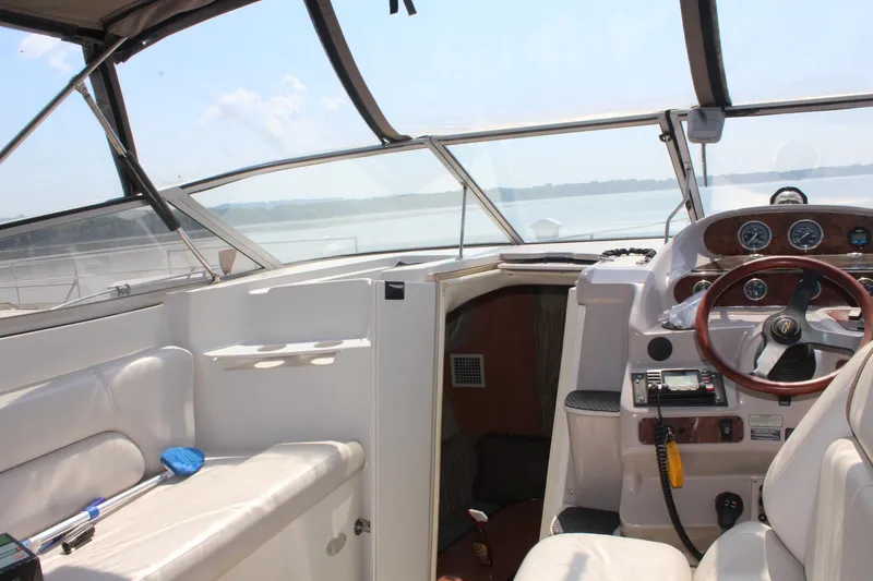 Slide: The Image of Interior view of 2000 Regal Commodore 2760 boat cockpit with steering wheel and seating. - 8