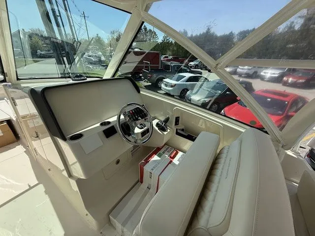 Slide: The Image of 2025 Grady-White Freedom 325 boat interior with steering wheel and seating. - 11