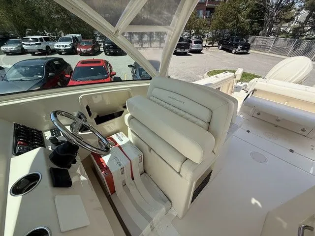 Slide: The Image of 2025 Grady-White Freedom 325 boat interior with steering wheel and seating. - 12