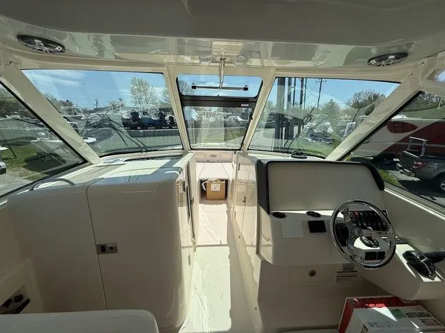 Slide: The Image of 2025 Grady-White Freedom 325 boat interior with steering wheel and dashboard view. - 14