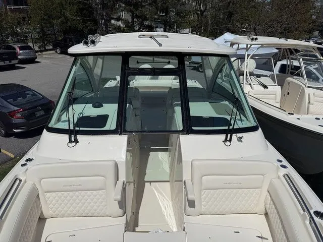 Slide: The Image of 2025 Grady-White Freedom 325 boat, front view, docked in a marina. - 16