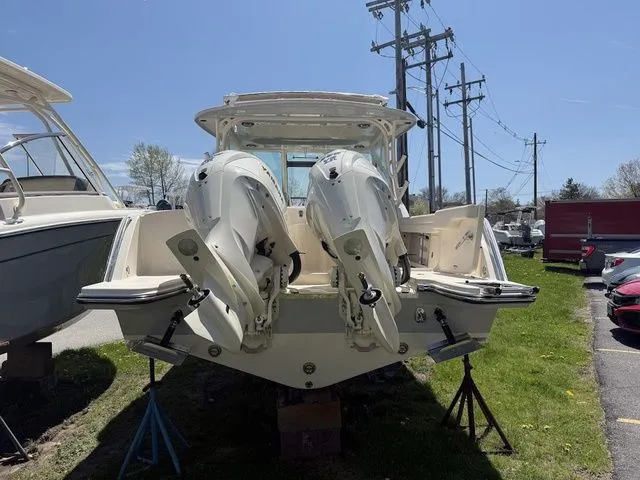 Slide: The Image of 2025 Grady-White Freedom 325 boat with dual outboard engines on display. - 5