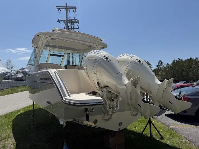 Slide: The Image of 2025 Grady-White Freedom 325 boat with dual outboard engines, parked outdoors. - 6