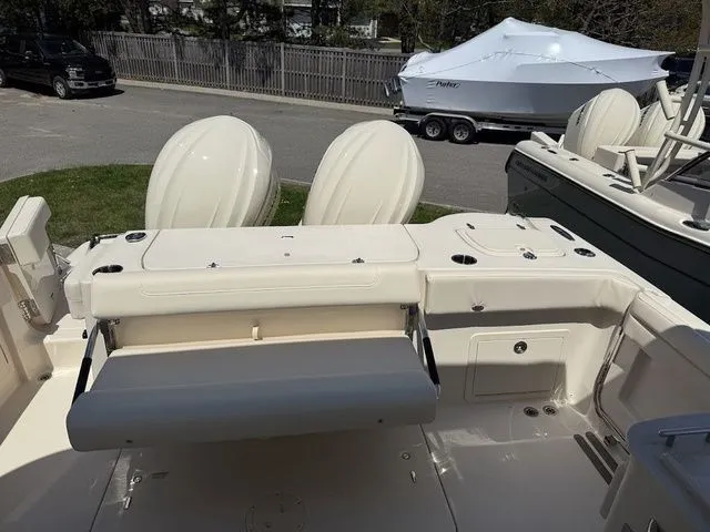 Slide: The Image of 2025 Grady-White Freedom 325 boat with dual outboard motors, docked outdoors. - 8