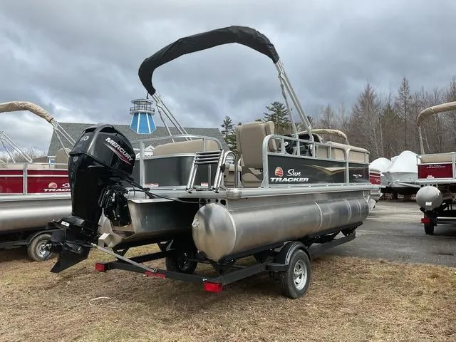 Slide: The Image of 2025 Sun Tracker PARTY BARGE® 18 DLX pontoon boat on trailer, outdoor setting. - 3