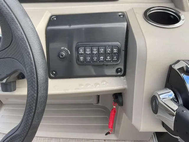 Slide: The Image of Control panel of 2025 Sun Tracker PARTY BARGE® 18 DLX with steering wheel and cup holder. - 8