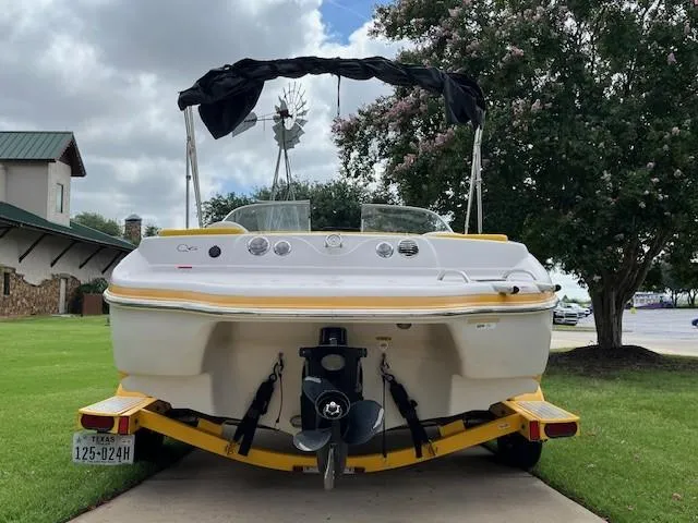 Slide: The Image of 2008 Tahoe Q6SF I/O boat on trailer, rear view, parked on driveway. - 3