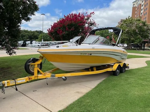 Slide: The Image of 2008 Tahoe Q6SF I/O boat on a yellow trailer, parked on a grassy area. - 6