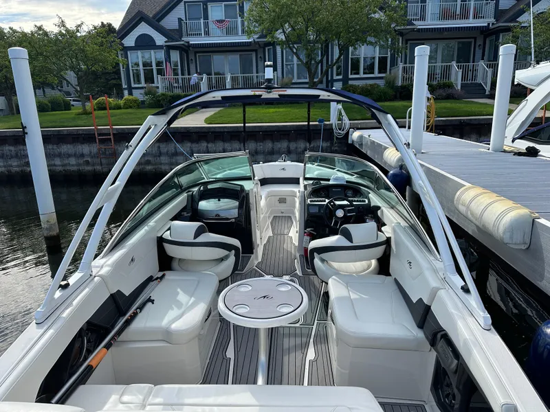 Slide: The Image of 2014 Monterey 268 Super Sport boat docked near waterfront homes. - 10