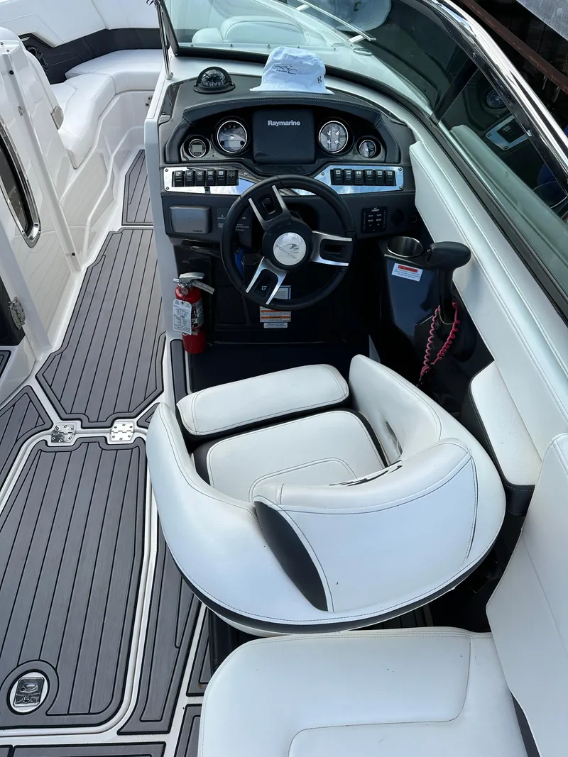 Slide: The Image of 2014 Monterey 268 Super Sport boat interior with steering wheel and seating. - 11