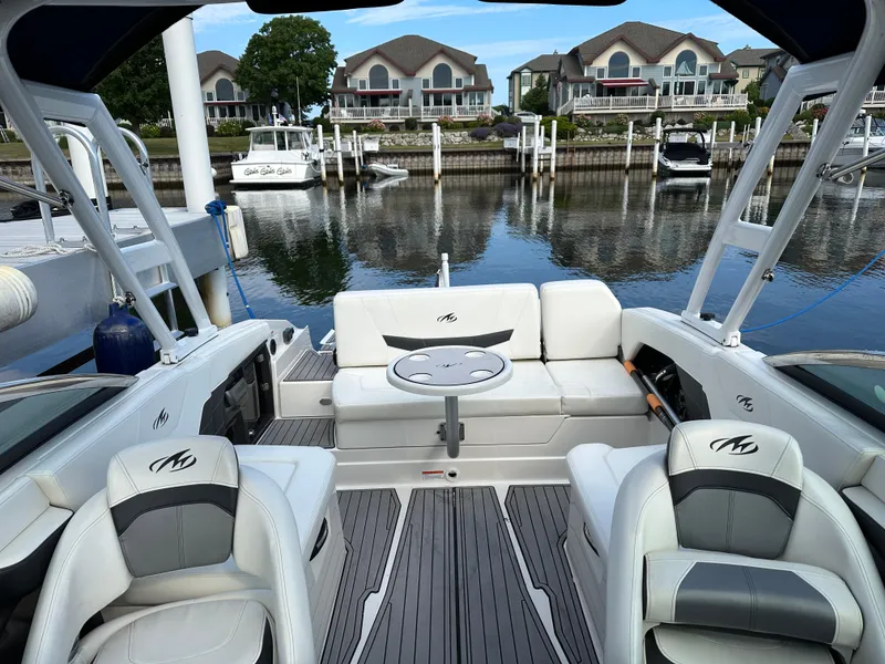 Slide: The Image of 2014 Monterey 268 Super Sport boat interior at a marina with waterfront homes. - 21
