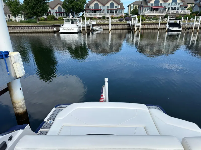 Slide: The Image of 2014 Monterey 268 Super Sport docked in a serene marina with waterfront homes. - 23