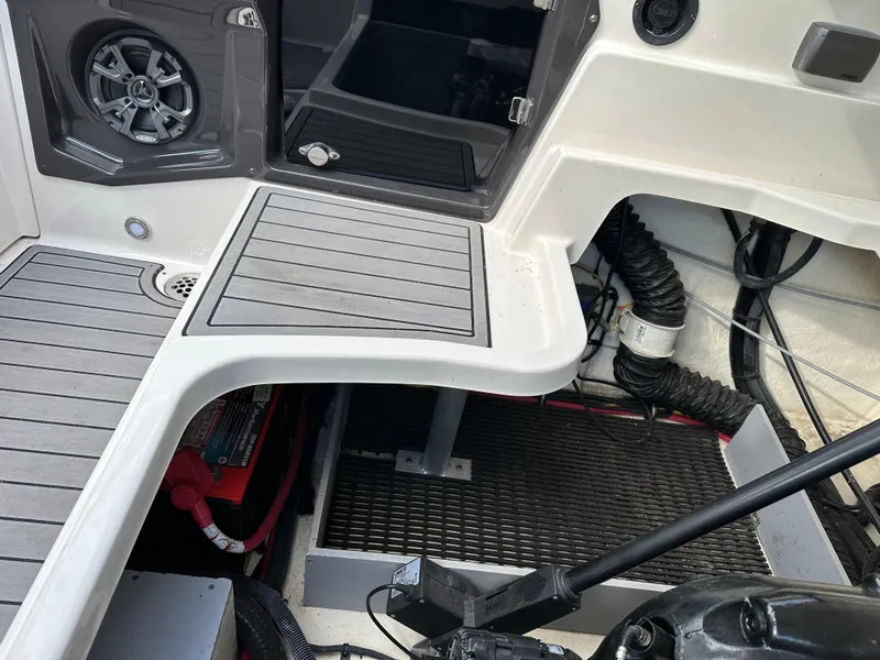 Slide: The Image of 2014 Monterey 268 Super Sport boat interior with speaker, battery, and wiring visible. - 28