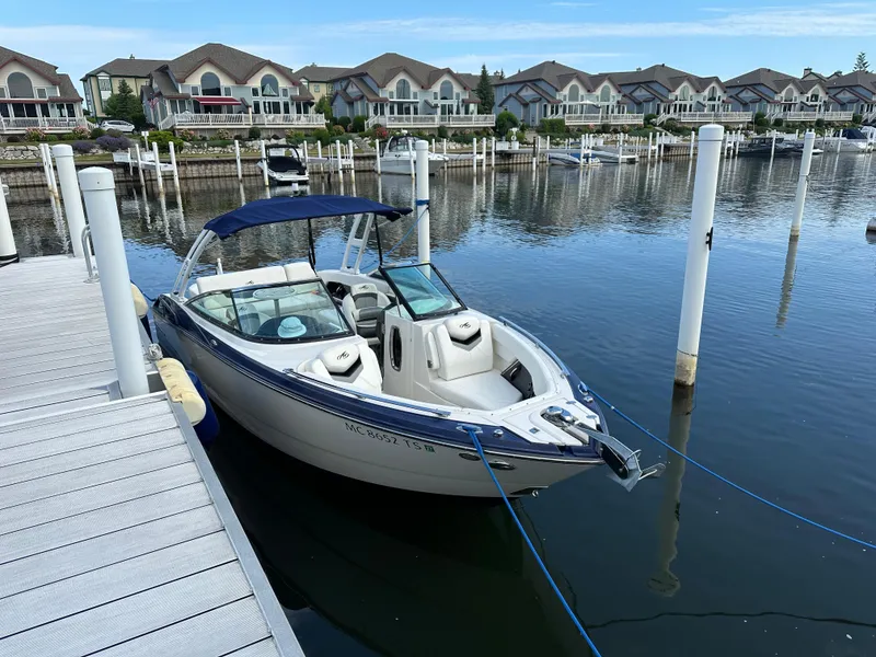 Slide: The Image of 2014 Monterey 268 Super Sport boat docked in a marina with waterfront homes. - 3