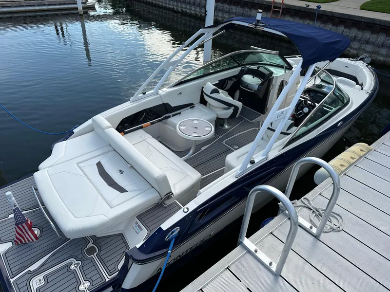 Slide: The Image of 2014 Monterey 268 Super Sport boat docked at marina with American flag. - 6