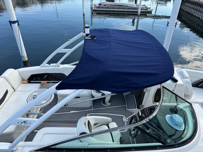 Slide: The Image of 2014 Monterey 268 Super Sport boat with blue canopy docked at marina. - 8