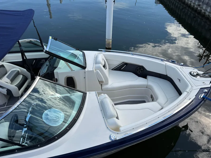 Slide: The Image of 2014 Monterey 268 Super Sport boat with white seating, docked on calm water. - 9