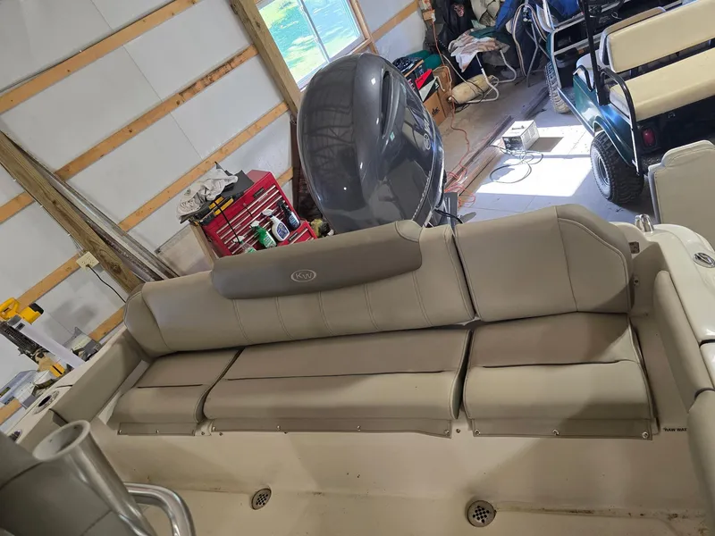 Slide: The Image of 2023 Key West 219 FS boat interior with beige seating in a garage setting. - 11