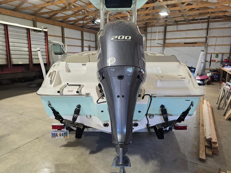 Slide: The Image of 2023 Key West 219 FS boat with Yamaha 200 engine in a garage setting. - 12