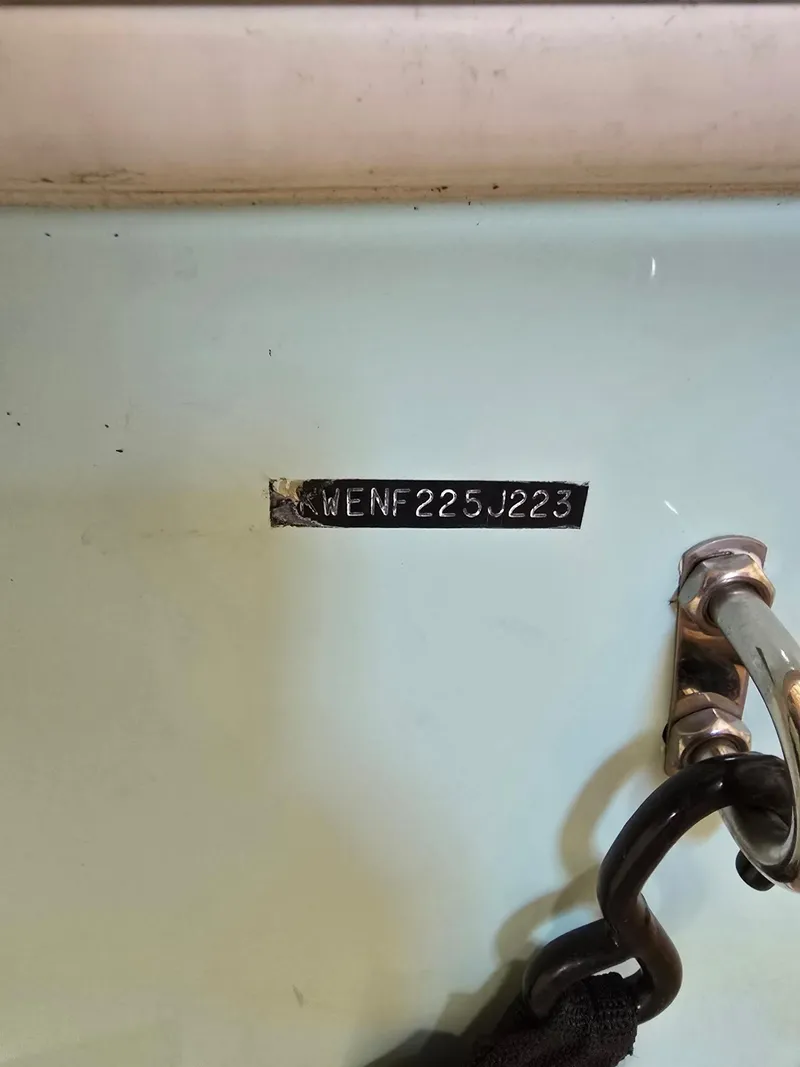 Slide: The Image of 2023 Key West 219 FS boat hull identification number and metal hook detail. - 13