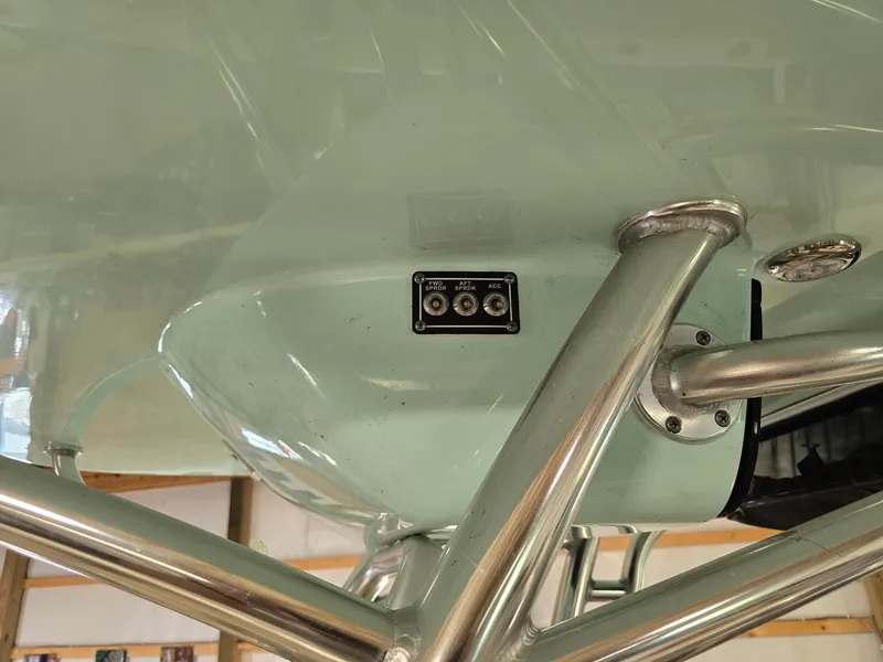 Slide: The Image of 2023 Key West 219 FS boat underside with metal supports and control panel. - 17