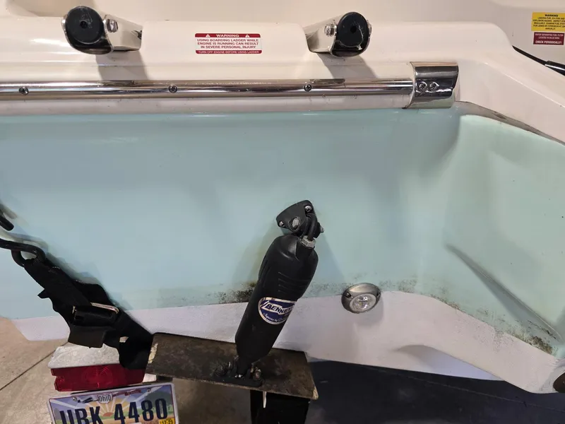 Slide: The Image of 2023 Key West 219 FS boat transom with hydraulic trim tab and Ohio license plate. - 18