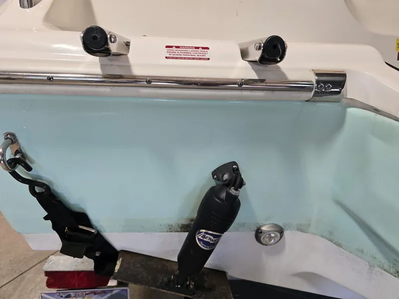 Slide: The Image of 2023 Key West 219 FS boat transom with hardware and warning label. - 19