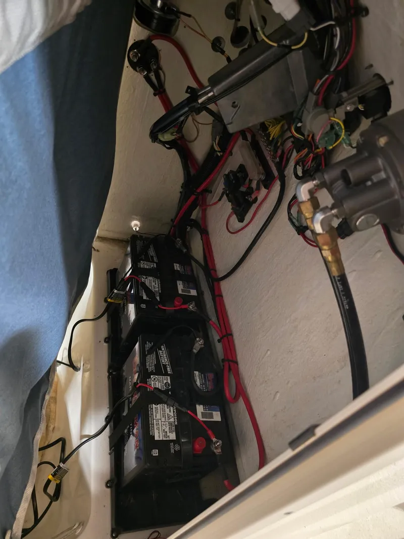 Slide: The Image of 2023 Key West 219 FS boat battery compartment with wiring and components. - 23