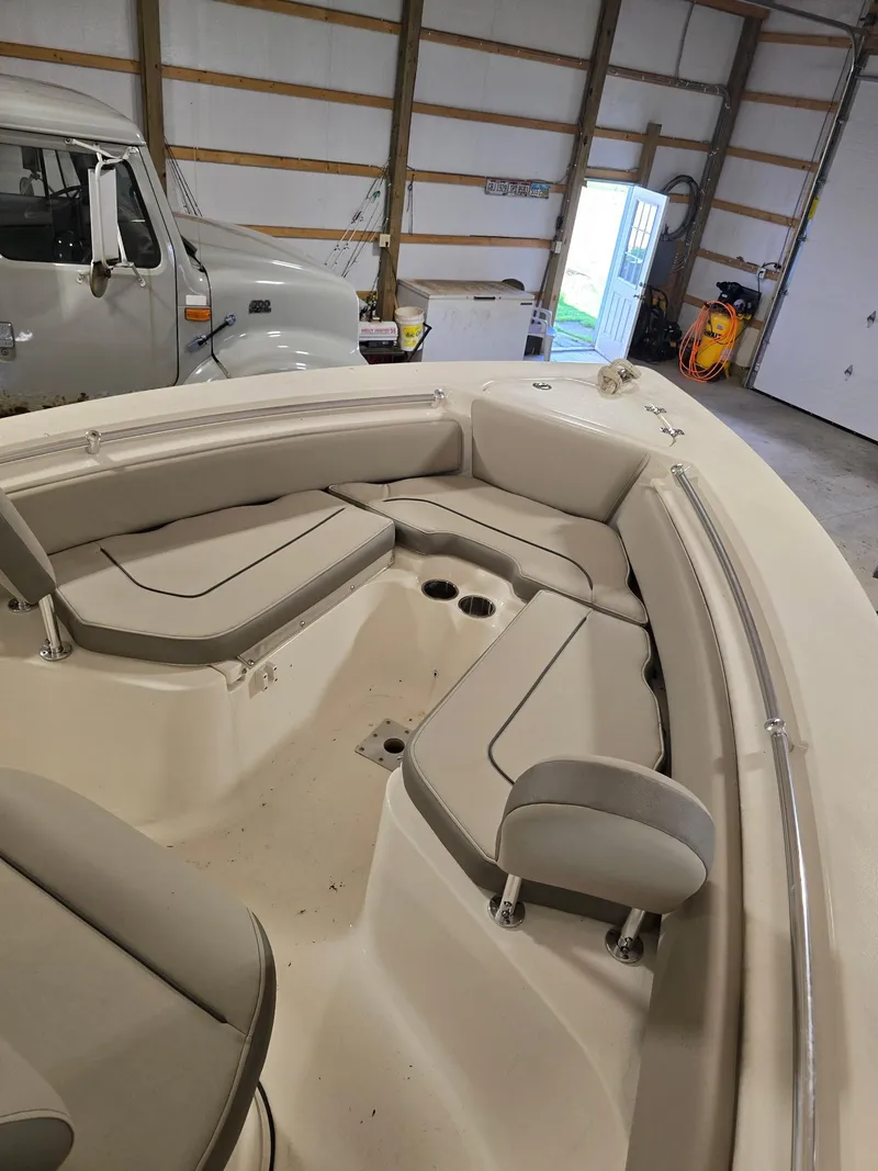 Slide: The Image of 2023 Key West 219 FS boat interior with cushioned seating in a garage. - 3