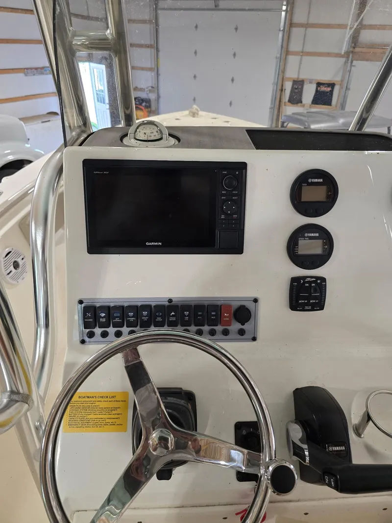 Slide: The Image of 2023 Key West 219 FS boat dashboard with Garmin display and Yamaha controls. - 6