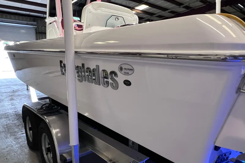 Slide: The Image of 2021 Everglades 253 Center Console boat on trailer in warehouse setting. - 10