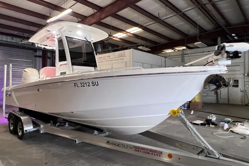 Slide: The Image of 2021 Everglades 253 Center Console boat on trailer in warehouse setting. - 14