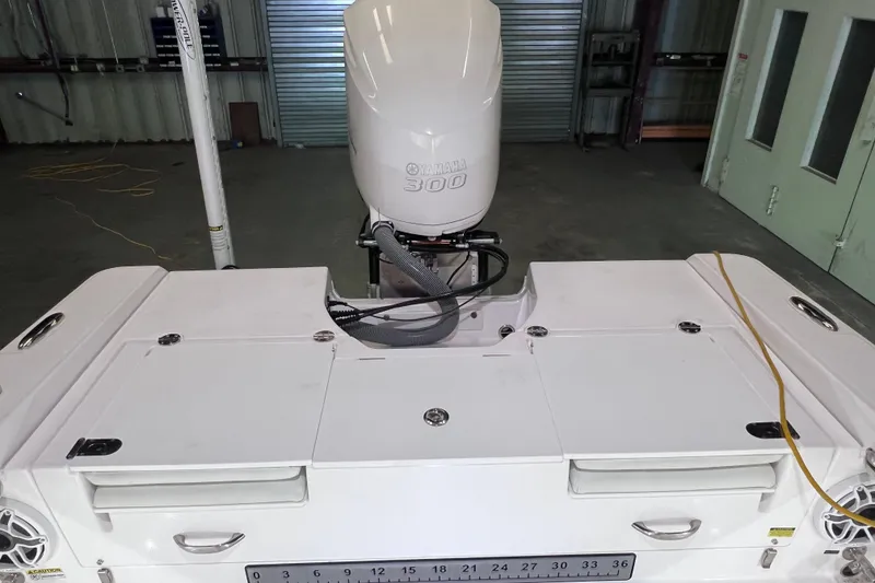 Slide: The Image of 2021 Everglades 253 Center Console boat with Yamaha 300 engine in a garage setting. - 19