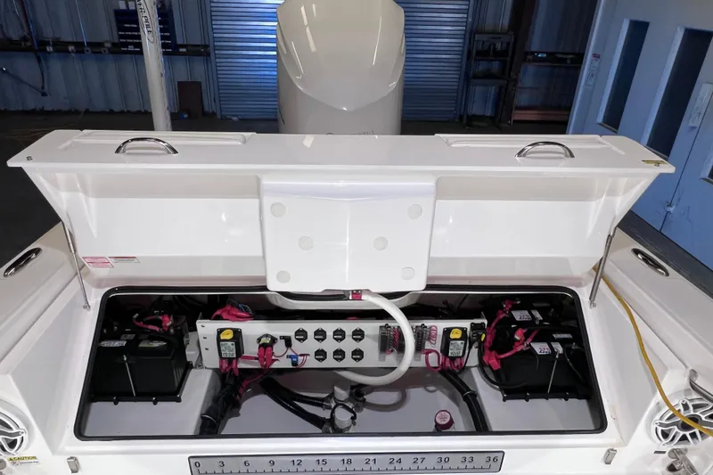 Slide: The Image of 2021 Everglades 253 Center Console boat's open storage compartment with electrical components. - 22