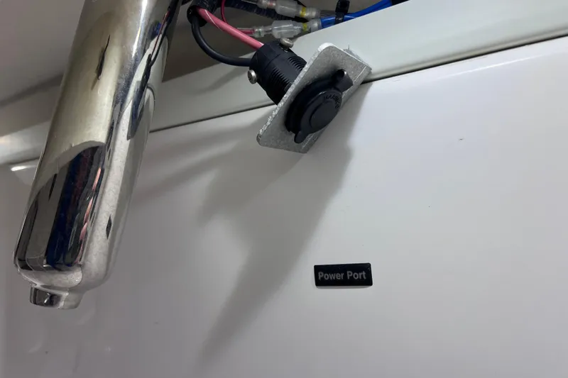 Slide: The Image of Power port on 2021 Everglades 253 Center Console boat, featuring chrome and wiring details. - 29