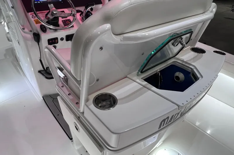 Slide: The Image of 2021 Everglades 253 Center Console boat interior with steering wheel and storage compartment. - 32